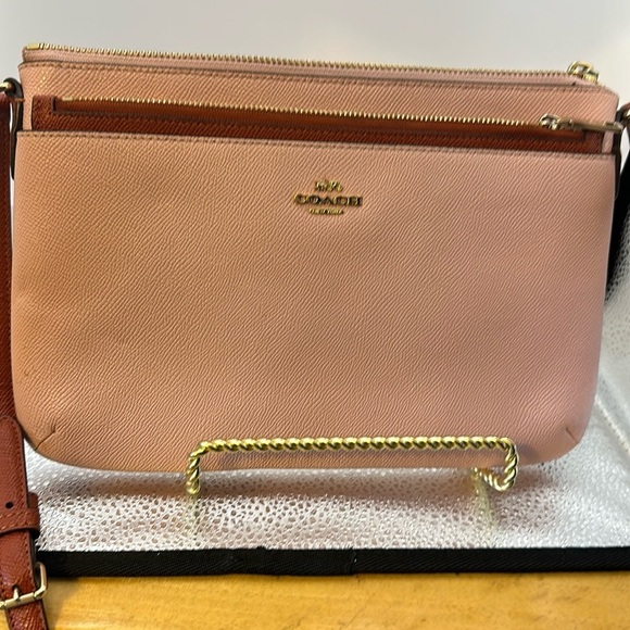 Coach Crossbody. Pedal pink with a brown leather strap.​​ - Picture 1 of 10